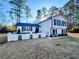 Charming two-story home with manicured lawn, decorative fence, and mature trees at 110 Randomwood Way, Alpharetta, GA 30022
