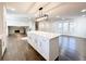 Bright kitchen features white countertops, an island, stainless steel appliances and dark wood floors at 110 Randomwood Way, Alpharetta, GA 30022