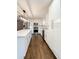 Bright kitchen features stainless steel appliances, white cabinets, countertops, and wood floors at 110 Randomwood Way, Alpharetta, GA 30022