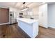 Bright kitchen features stainless steel appliances, white countertops, an island and wood floors at 110 Randomwood Way, Alpharetta, GA 30022