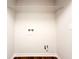 Laundry room with wood floors and white walls, ready for customization and appliances at 110 Randomwood Way, Alpharetta, GA 30022