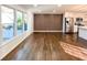 Bright living room featuring beautiful hardwood floors and a modern accent wall at 110 Randomwood Way, Alpharetta, GA 30022