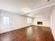 Bright living room with a white fireplace, wood flooring, and ample natural light at 110 Randomwood Way, Alpharetta, GA 30022