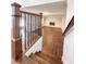 Wooden staircase leads to an open living space with a cozy fireplace at 110 Randomwood Way, Alpharetta, GA 30022