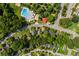 Aerial view highlighting the community pool near homes nestled among lush trees and greenery at 1751 Thomasville Se Dr, Atlanta, GA 30315