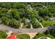 Birds-eye view of a house surrounded by mature trees, highlighting its setting within a neighborhood at 1751 Thomasville Se Dr, Atlanta, GA 30315