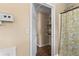 View into bathroom featuring a tub with a yellow floral shower curtain and built-in shelving at 1751 Thomasville Se Dr, Atlanta, GA 30315