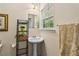 Bright bathroom with pedestal sink, stylish fixtures, and a large window at 1751 Thomasville Se Dr, Atlanta, GA 30315