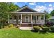 Charming single Gathering home with a cozy front porch and well-manicured lawn at 1751 Thomasville Se Dr, Atlanta, GA 30315