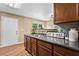 Kitchen featuring wood cabinets, and stainless steel sink, and view to dining area at 1751 Thomasville Se Dr, Atlanta, GA 30315