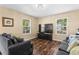 Cozy living room featuring hardwood floors, two couches, and abundant natural light from two windows at 1751 Thomasville Se Dr, Atlanta, GA 30315