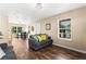 Cozy living room with hardwood floors, comfortable seating, and a view into the dining area at 1751 Thomasville Se Dr, Atlanta, GA 30315