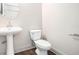 Powder room featuring a pedestal sink, toilet, and modern fixtures at 1192 Wylie Se St # 429, Atlanta, GA 30316