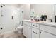 Bathroom featuring double sinks, white cabinetry, and a glass shower at 1192 Wylie Se St # 429, Atlanta, GA 30316