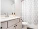Well-lit bathroom featuring a stylish vanity, toilet and tub-shower combination with elegant curtain at 1192 Wylie Se St # 429, Atlanta, GA 30316