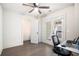 Bright bedroom with dark hardwood floors, ceiling fan, closet, and double doors to a balcony at 1192 Wylie Se St # 429, Atlanta, GA 30316
