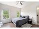 Bedroom with hardwood floors, two windows, and a comfortable bed at 1192 Wylie Se St # 429, Atlanta, GA 30316