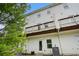 Exterior of home showcasing balconies, white siding, back door, and landscaped backyard at 1192 Wylie Se St # 429, Atlanta, GA 30316