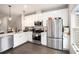 Modern kitchen with stainless steel appliances, white cabinets, and sleek countertops at 1192 Wylie Se St # 429, Atlanta, GA 30316