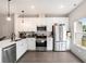 Contemporary kitchen featuring stainless appliances, pristine white cabinets, and a window with natural light at 1192 Wylie Se St # 429, Atlanta, GA 30316