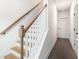 Bright hallway featuring wooden staircase with white banister and modern door frames at 1192 Wylie Se St # 429, Atlanta, GA 30316
