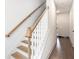Bright staircase featuring hardwood steps and white railings at 1192 Wylie Se St # 429, Atlanta, GA 30316