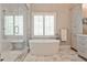 Bright bathroom featuring a freestanding tub, walk-in shower, and marble flooring at 156 Lake Forrest Ne Ln, Atlanta, GA 30342