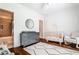 Bedroom with a crib, dresser, and view into an adjoining bathroom at 156 Lake Forrest Ne Ln, Atlanta, GA 30342