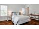 Bedroom with hardwood floors, a queen bed, and natural light from windows with shutters at 156 Lake Forrest Ne Ln, Atlanta, GA 30342