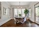 Charming dining room with large windows, a round table, comfortable seating, and hardwood floors at 156 Lake Forrest Ne Ln, Atlanta, GA 30342