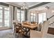 Airy dining room with natural light, rustic table, and views to the exterior at 156 Lake Forrest Ne Ln, Atlanta, GA 30342