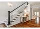 Bright foyer with a staircase, hardwood floors, and stylish furnishings at 156 Lake Forrest Ne Ln, Atlanta, GA 30342
