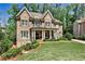 Beautiful brick home with meticulously maintained lawn and mature trees on a sunny day at 156 Lake Forrest Ne Ln, Atlanta, GA 30342