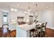 Well-lit kitchen featuring white cabinets, marble countertops, an island with seating, and hardwood floors at 156 Lake Forrest Ne Ln, Atlanta, GA 30342