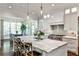 Charming kitchen showcasing an island with seating, stainless steel appliances, and view into dining area at 156 Lake Forrest Ne Ln, Atlanta, GA 30342