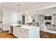 Bright kitchen with marble island and view to the living room including built-in shelving and a fireplace at 156 Lake Forrest Ne Ln, Atlanta, GA 30342