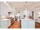 Spacious kitchen showcasing stainless steel appliances, marble countertops, and an island with seating at 156 Lake Forrest Ne Ln, Atlanta, GA 30342