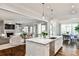 Open-concept kitchen with stainless steel appliances, marble countertops, and view of dining/living area at 156 Lake Forrest Ne Ln, Atlanta, GA 30342