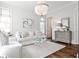 Bright living room with white furniture, modern chandelier, and hardwood floors at 156 Lake Forrest Ne Ln, Atlanta, GA 30342