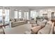 Open living room with French doors and view into kitchen; features neutral tones and comfortable seating at 156 Lake Forrest Ne Ln, Atlanta, GA 30342