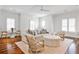 Bright living room with hardwood floors, large windows, and comfortable seating at 156 Lake Forrest Ne Ln, Atlanta, GA 30342