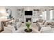 Bright living room featuring built-in shelving, a fireplace, comfortable seating and neutral tones at 156 Lake Forrest Ne Ln, Atlanta, GA 30342