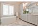 Bright main bathroom with freestanding tub, double vanity, and lots of storage at 156 Lake Forrest Ne Ln, Atlanta, GA 30342