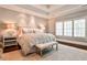 Serene main bedroom with tray ceiling, neutral colors, and plantation shutters at 156 Lake Forrest Ne Ln, Atlanta, GA 30342