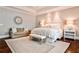 Serene main bedroom with tray ceiling, sitting area, neutral colors, and plantation shutters at 156 Lake Forrest Ne Ln, Atlanta, GA 30342