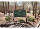 Welcome sign to Chastain Park with colorful flower beds in front and lush trees around, creating a charming entrance at 156 Lake Forrest Ne Ln, Atlanta, GA 30342