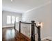 Upstairs landing features dark hardwood floors and lots of natural light from windows at 156 Lake Forrest Ne Ln, Atlanta, GA 30342