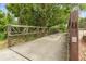 Scenic walking bridge lined with mature trees and green foliage, an idyllic place for a walk or bike ride at 156 Lake Forrest Ne Ln, Atlanta, GA 30342