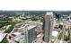 Stunning aerial view of luxury high-rise condos and surrounding cityscape with lush green trees, providing an urban oasis at 270 17Th Nw St # 2210, Atlanta, GA 30363