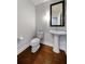 Bathroom features pedestal sink, toilet, hardwood floors, and large framed mirror at 270 17Th Nw St # 2210, Atlanta, GA 30363